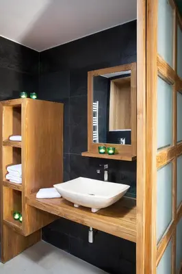 a bathroom with a sink and a mirror at AJOUCADOU le perchoir in Lourmarin