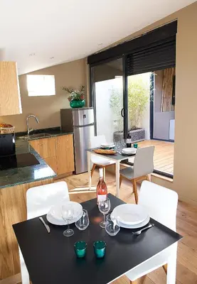 a kitchen and dining room with a table and chairs at AJOUCADOU le perchoir in Lourmarin