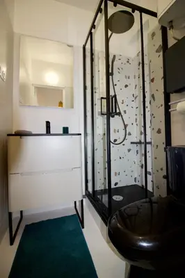 a bathroom with a shower with a toilet and a sink at Le Petit Marius in Aix-en-Provence
