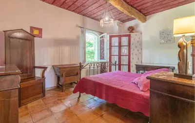 a bedroom with a bed and a dresser and a window at 4 Bedroom Pet Friendly Home In Apt in Apt