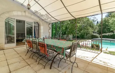 a table and chairs on a patio with a pool at 4 Bedroom Pet Friendly Home In Apt in Apt