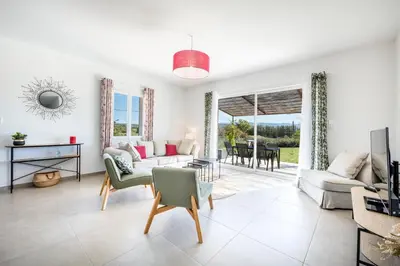 a living room with a couch and a table at Villa Piscine Chauffée & climatisation, 5min du village in Saint-Saturnin-les-Apt