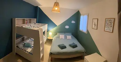 a childs room with two bunk beds and a staircase at Villa Noa Pertuis in Pertuis