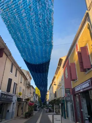 a large blue object is hanging over a street at Villa Noa Pertuis in Pertuis