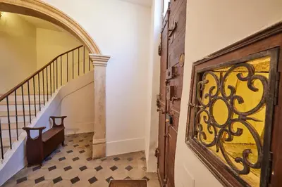 a hallway with a wooden door and a staircase at Le Clos des Merveilles in Rognes