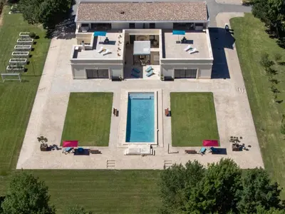 an aerial view of a house with a swimming pool at Domaine des Eucalyptus in Mollégès