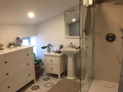 a bathroom with a sink and a shower at Gîte Coquelicots in Montsalier