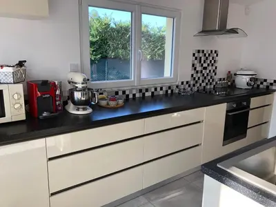 a kitchen with white cabinets and a window at Villa avec vue campagne in Carpentras