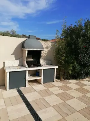 a pizza oven sitting on top of a patio at JULIANA in Eyragues