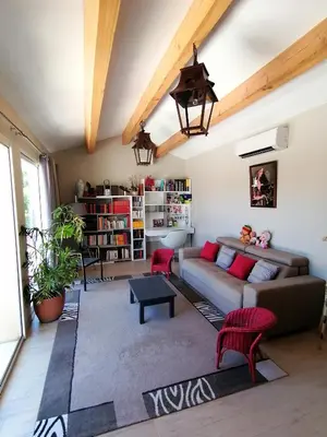 a living room with a couch and red chairs at JULIANA in Eyragues