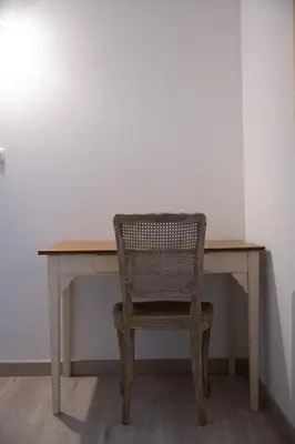 a chair sitting at a wooden desk in a room at Entre blé et lavande in Bonnieux