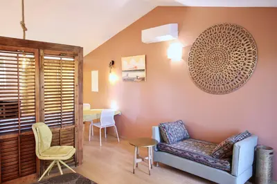 a living room with a couch and a table at Le Jardin d'Érables St Remy 7 HA Piscine/Clim in Paluds de Noves