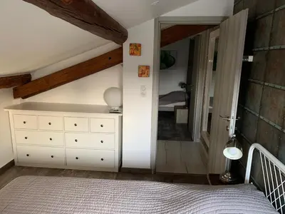 a bedroom with a white dresser and a mirror at Clos du Cardinal in LʼIsle-sur-la-Sorgue