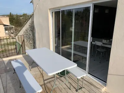 a white table and chairs on a balcony at Clos du Cardinal in LʼIsle-sur-la-Sorgue