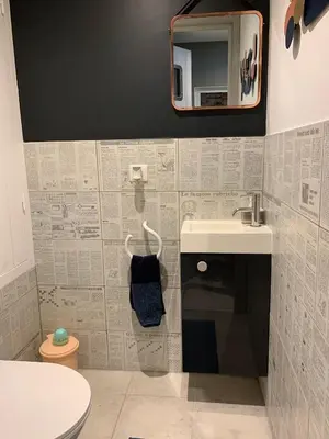 a bathroom with a sink and a toilet and a mirror at Clos du Cardinal in LʼIsle-sur-la-Sorgue