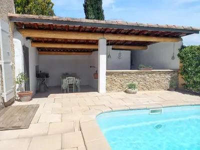 a patio with a swimming pool and a pergola at Maison avec piscine privée à Caromb, idéale pour famille in Caromb