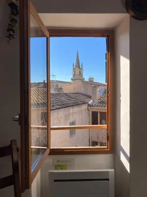 a window in a room with a view of a church at Pélissanne, superbe appartement entièrement rénové in Pélissanne