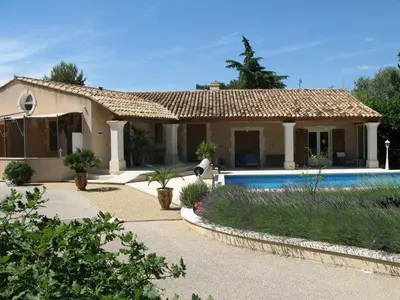 a house with a swimming pool in front of it at CABANE perchée dans les arbres in Robion en Luberon