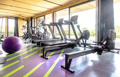 a gym with a bunch of treadmills and machines at thecamp hôtel - Aix en Provence in Aix-en-Provence