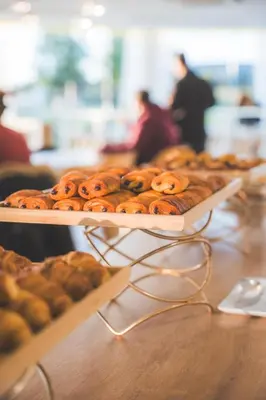 a tray of donuts on a table in a bakery at thecamp hôtel - Aix en Provence in Aix-en-Provence