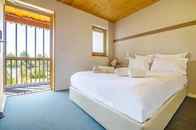 a bedroom with a large white bed and a window at thecamp hôtel - Aix en Provence in Aix-en-Provence