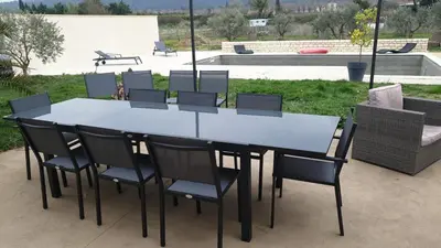 a white table and chairs with a patio at Villa à charleval en campagne avec piscine 14 couchages in Charleval