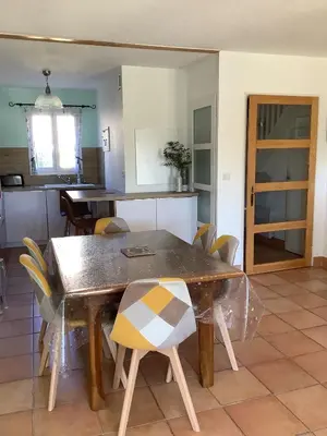 a dining room with a table and chairs at Les Oliviers in Mallemort