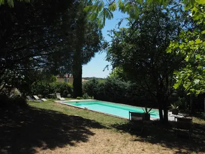 a swimming pool in a yard with trees at Cozy Vacation House with Pool, Vernègues in Vernègues