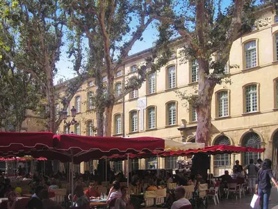 a group of people sitting at tables in front of a building at Cozy Vacation House with Pool, Vernègues in Vernègues