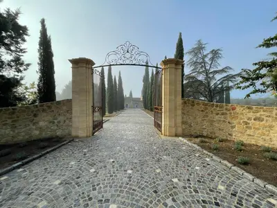 an entrance to a stone fence with an archway at Château Saint-Pierre de Mejans in Puyvert