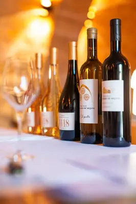 three bottles of wine sitting on a table with glasses at Château Saint-Pierre de Mejans in Puyvert