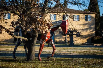 a kite is standing next to a tree at Château Saint-Pierre de Mejans in Puyvert