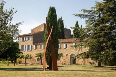 a large sculpture in front of a building at Château Saint-Pierre de Mejans in Puyvert