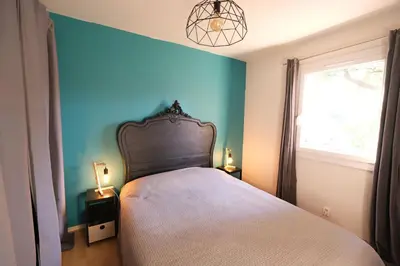 a bedroom with a bed and a blue wall at villa with pool and beautiful view in the luberon in pujet sur durance - 10 in Puget