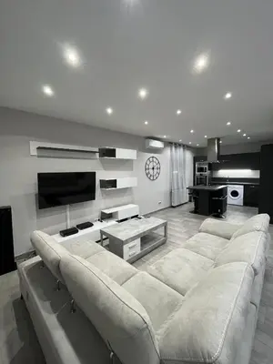 a living room with a large couch and a tv at Logement privé à proximité du Mont Ventoux in Carpentras