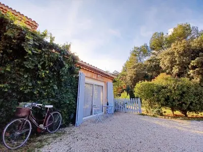 a bike parked next to a building with a garage at Bastide Cedrea in Peyrolles-en-Provence