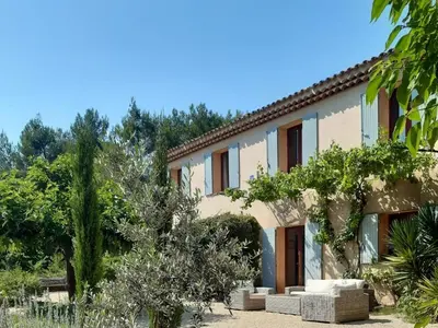 an exterior view of a house with trees at Bastide Cedrea in Peyrolles-en-Provence