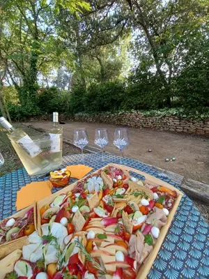 a tray of food on a table with wine glasses at Bastide Cedrea in Peyrolles-en-Provence