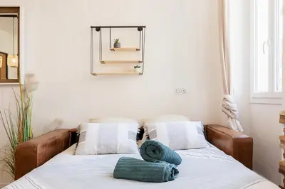a bed with two pillows on it in a room at Woods Natural Hyper centre Fontaine Moussue in Salon-de-Provence