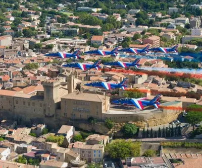 a bunch of flags flying over a city at Exotic Stones Hyper Centre Fontaine Moussue in Salon-de-Provence