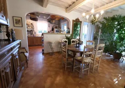 a patio with a table and chairs next to a pool at jolie location, maison avec piscine et joli jardin fleuri, à oppède dans le luberon en provence – 6 personnes in Oppède