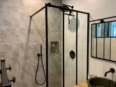a bathroom with a shower with a glass door at La Parenthese Saint Donat in Aix-en-Provence