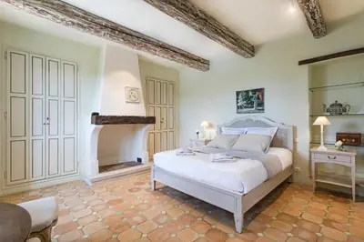 a bedroom with a white bed and a table at Pavillon Lou in Crillon-le-Brave
