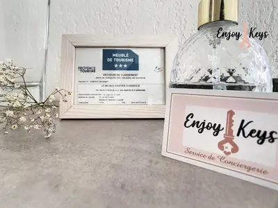 a bottle of wine next to a picture and a sign at Au pied du Château de l'Empéri in Salon-de-Provence