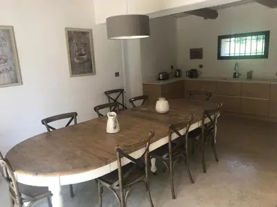 a table with chairs and vases on it in a kitchen at MAS DE CHARME EN PROVENCE in Le Thor