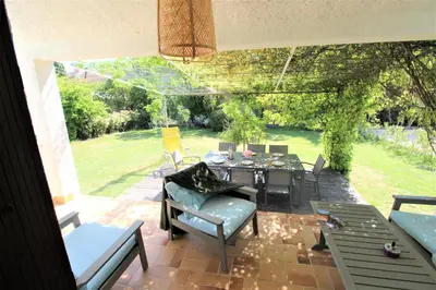 a patio with a table and chairs on a patio at Les Bastidons de L'Isle - Le Saint-Julien - 3 étoiles in LʼIsle-sur-la-Sorgue