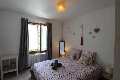 a bedroom with a bed with a teddy bear on it at Les Bastidons de L'Isle - Le Saint-Julien - 3 étoiles in LʼIsle-sur-la-Sorgue