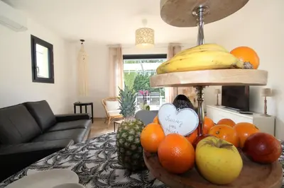 a bowl of fruit on a table in a living room at Les Bastidons de l'Isle - Le Seguret - 3 étoiles in LʼIsle-sur-la-Sorgue