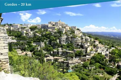 a city on top of a hill with houses at Les Bastidons de l'Isle - Le Seguret - 3 étoiles in LʼIsle-sur-la-Sorgue