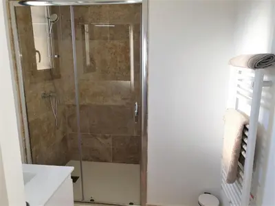a shower with a glass door in a bathroom at Les Bastidons de l'Isle - Le Seguret - 3 étoiles in LʼIsle-sur-la-Sorgue
